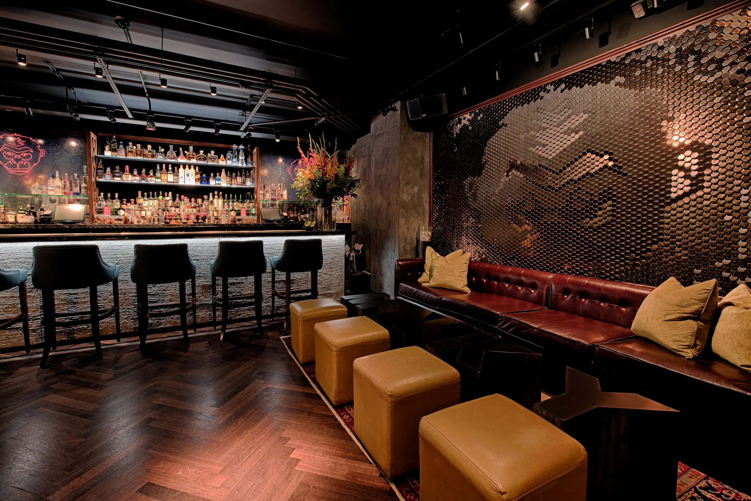 Hotel suite living room with teal upholstered seating, circular chandelier, and panoramic Bosphorus views